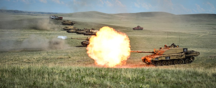 A line of Challenger 2's fire as part of the Royal Welsh Battle Group during Exercise Prairie Lightning.